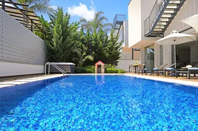 a swimming pool in front of a villa at Villa Sunrise Glory - 150m from Trinity Beach in Protaras