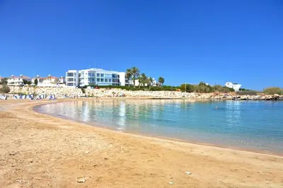 a group of people walking on the beach at Villa Sunrise Glory - 150m from Trinity Beach in Protaras