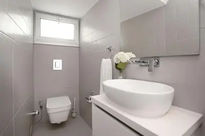 a white bathroom with a sink and a toilet at Villa Sunrise Memory - 150m from Trinity Beach in Protaras