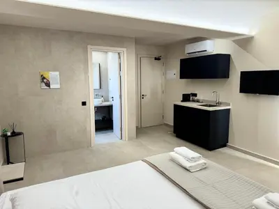 a hotel room with a bed and a sink at Home of the Muses in Ayia Napa