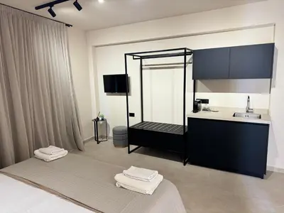 a bathroom with two beds and a sink at Home of the Muses in Ayia Napa