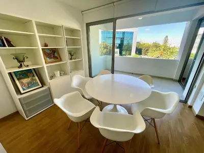 a white table and chairs in a room with a window at Spacious Apartment in Nicosia Landmark Hotel Area - Stasinou By Platform 357 in Strovolos