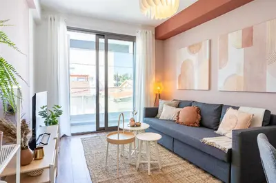 a living room with a blue couch and a table at Arion 1-Bedroom Apartment in Larnaca in Larnaka