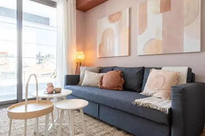 a living room with a blue couch and a table at Arion 1-Bedroom Apartment in Larnaca in Larnaka