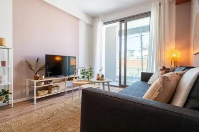a living room with a couch and a tv at Arion 1-Bedroom Apartment in Larnaca in Larnaka