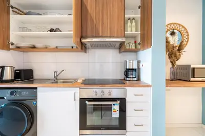 a kitchen with a stove and a dishwasher at Hue 1-Bedroom Apartment in Larnaca in Larnaka