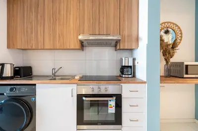 a kitchen with a stove and a dishwasher at Hue 1-Bedroom Apartment in Larnaca in Larnaka