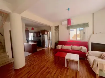 a living room with a red couch and a table at Platform 357 Mimoza Villa with View in Paralimni