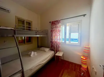 a bedroom with a bunk bed and a window at Platform 357 Mimoza Villa with View in Paralimni