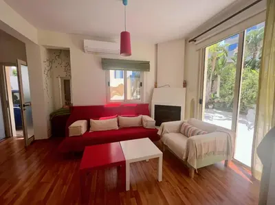 a living room with a red couch and a table at Platform 357 Mimoza Villa with View in Paralimni