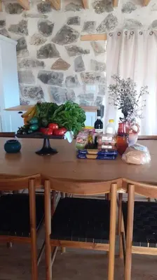 a table with a bunch of vegetables on it at Serenity Mountain in Askas