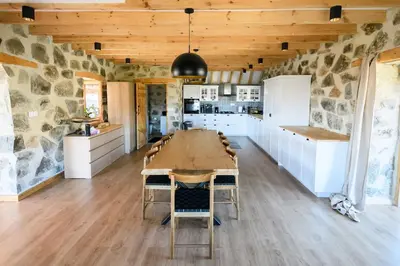 a kitchen and dining room with a table and chairs at Serenity Mountain in Askas
