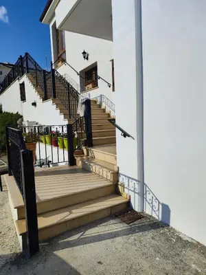 a set of stairs leading up to a house at Mariam Apartment in Larnaka