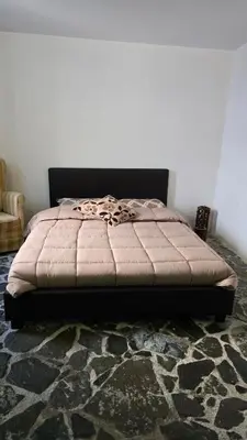 a bed sitting in a room with at GPPh in Pelendri
