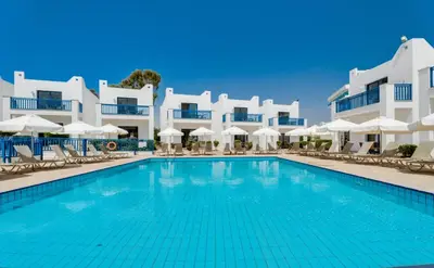 a swimming pool in front of a hotel at Kritamo Beach Hotel Apartments in Ayia Napa