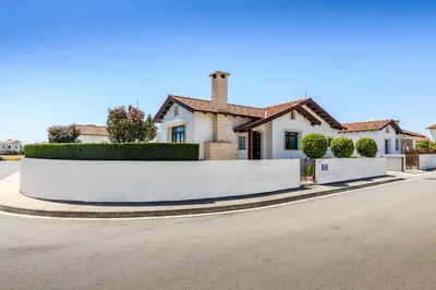 a white fence in front of a house at Kymma Bungalow #2 in Ayia Napa