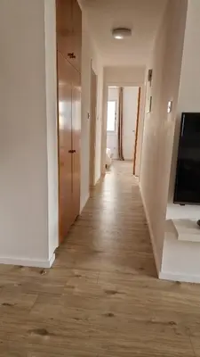 a hallway of an apartment with a wooden floor at City Center Apartment 2 in Nicosia