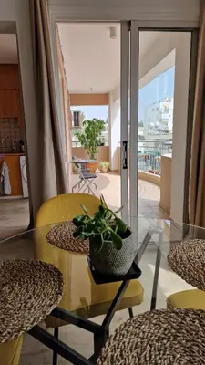 a glass table with a potted plant on it in a room at City Center Apartment 2 in Nicosia