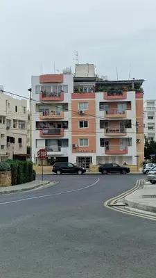 a stop sign in front of a large building at City Center Apartment 2 in Nicosia
