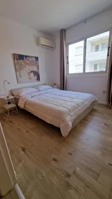 a large bed in a bedroom with a large window at City Center Apartment 2 in Nicosia