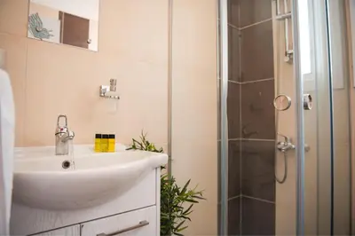 a bathroom with a sink and a shower at Mercury Apartment in Livadhia