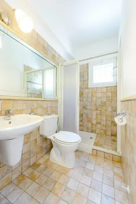 a bathroom with a toilet and a sink and a tub at Villa Marilena in Protaras