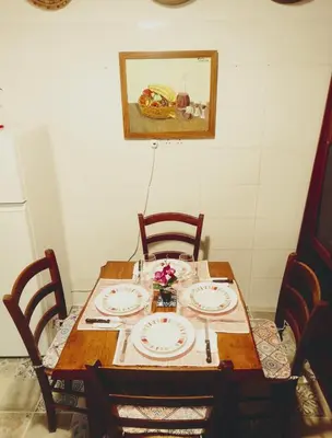 a dining room table with plates and flowers on it at Traditional House in Pera in Pera