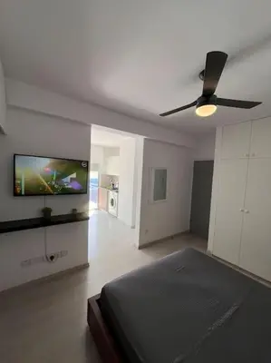 a bedroom with a bed and a flat screen tv at Top floor Flat in Nicosia 2 in Nicosia