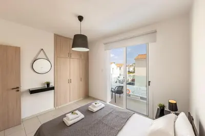 a bedroom with a bed with two towels on it at The Second Diamond Protara - 2' Walk to Beach in Protaras