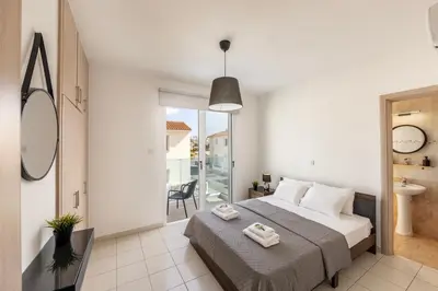 a bedroom with a bed and a bathroom at The Second Diamond Protara - 2' Walk to Beach in Protaras