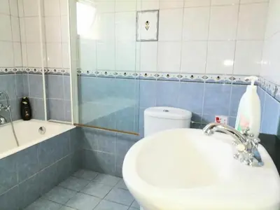 a bathroom with a sink and a tub and a toilet at Villa Elena Gardens in Ayia Napa