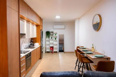 a kitchen with a table and chairs in a room at Earth Apartment in Larnaka