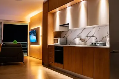 a kitchen with a sink and a stove at Earth Apartment in Larnaka