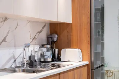 a kitchen counter with a sink and a toaster at Earth Apartment in Larnaka