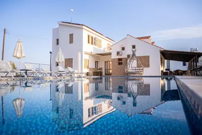 a villa with a swimming pool in front of a building at Konnos Villa 1 in Protaras