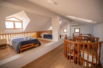 a attic bedroom with a bed and a staircase at Konnos Villa 1 in Protaras