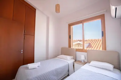 a bedroom with two beds and a window at Konnos Villa 1 in Protaras
