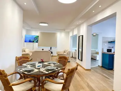 a dining room with a table and chairs at Neptune Apartment in Larnaka