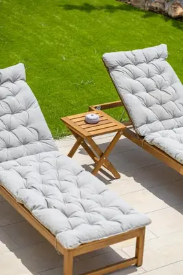 two lounge chairs and a wooden table on a patio at Luxury Seaview Limassol Villa Pool Jacuzzi Sauna in Limassol