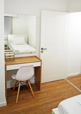 a bedroom with a desk and a bed and a chair at Modern apartment near McKenzie beach in Larnaka