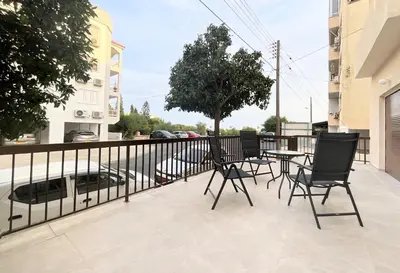 a patio with chairs and a table on a balcony at Modern apartment near McKenzie beach in Larnaka