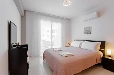 a bedroom with a bed with two towels on it at Stylish One-Bedroom Sea Retreat in Paralimni