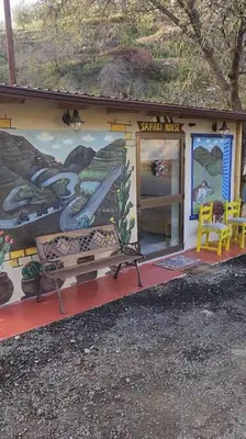 a small building with a bench in front of it at Safari House with fireplace in Agros
