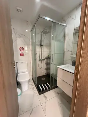 a bathroom with a glass shower and a toilet at Le Voyageur II in Larnaka