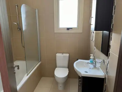 a bathroom with a toilet and a sink and a shower at Paez Villa in Protaras