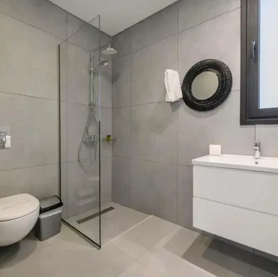 a bathroom with a shower and a toilet and a sink at By the beach Villa 2 in Protaras