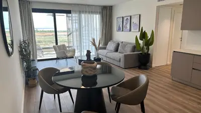 a living room with a table and chairs and a couch at Sunset Gardens - Holiday Apartments in Limassol