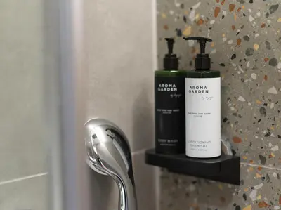 two bottles of soap and a blow dryer on a bathroom sink at Le Vert Suites Platres in Platres