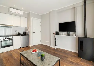a living room with a table and a kitchen at Le Vert Suites Platres in Platres