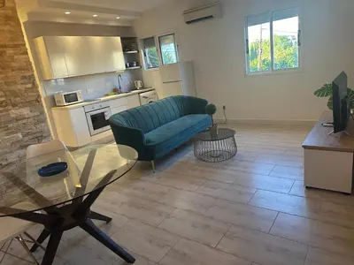 a living room with a couch and a glass table at Appartments 750m from beach, tourist area in Limassol